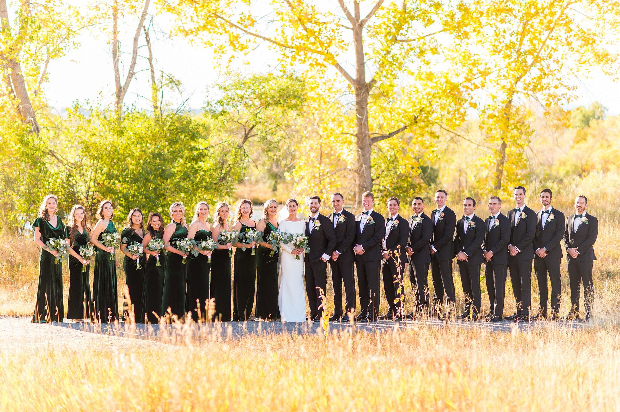 Bridal party, bride and groom pose for wedding portrait photos at Belmar Park in Lakewood, Colorado.