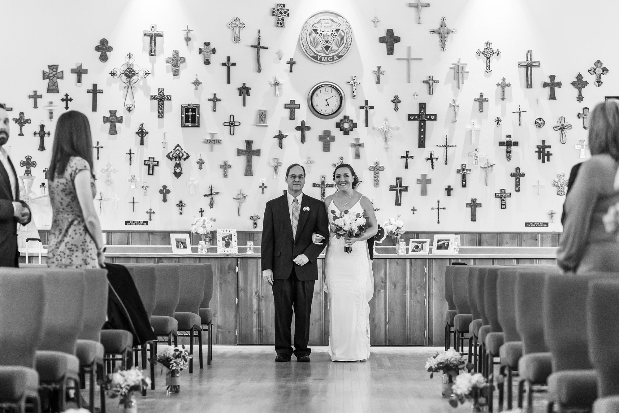 The bride processes in with her father during her YMCA of the Rockies wedding in Estes Park, Colorado.