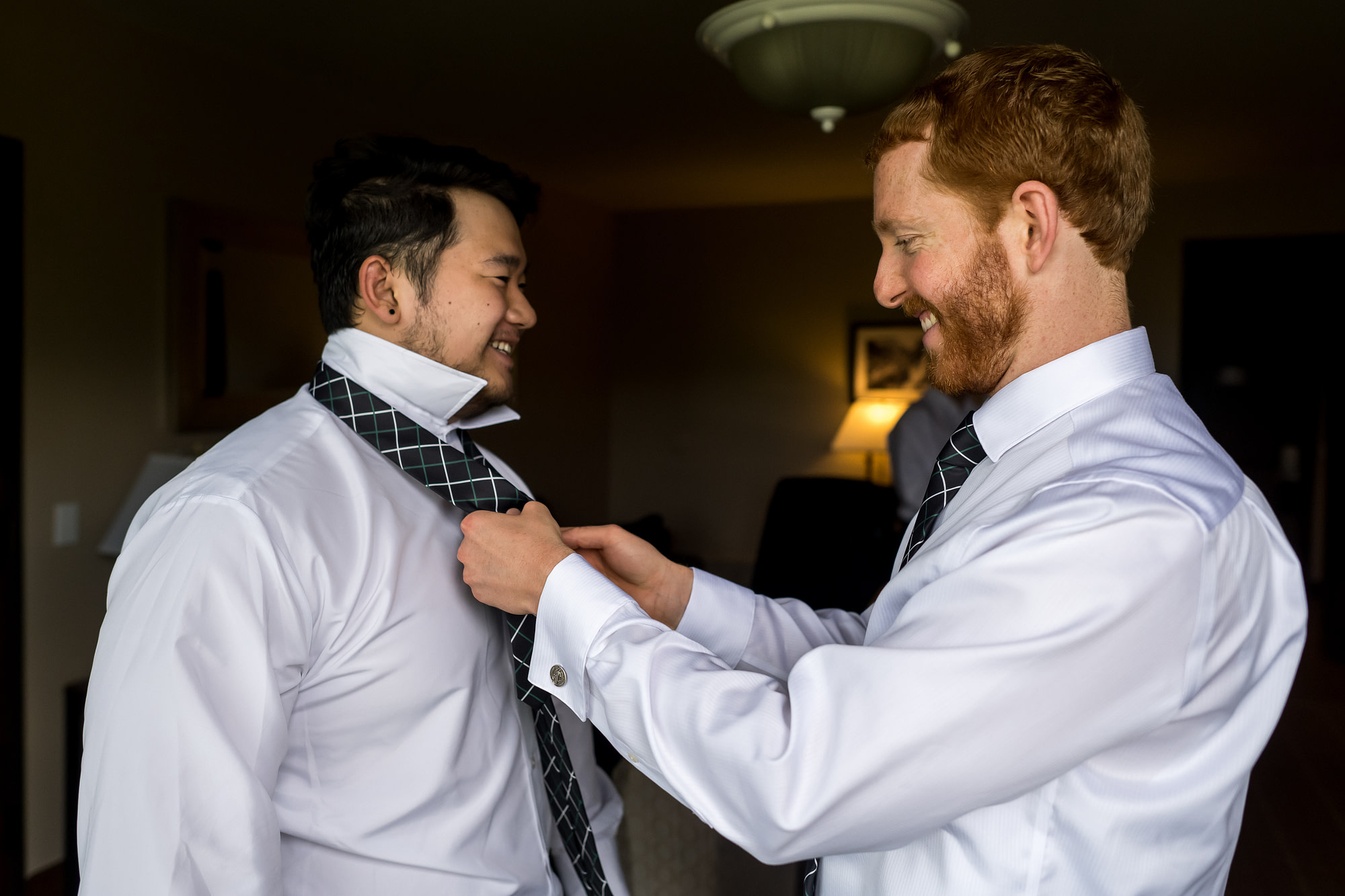 The groom adjusts the tie of a groomsman before his Telluride, Colorado, wedding.