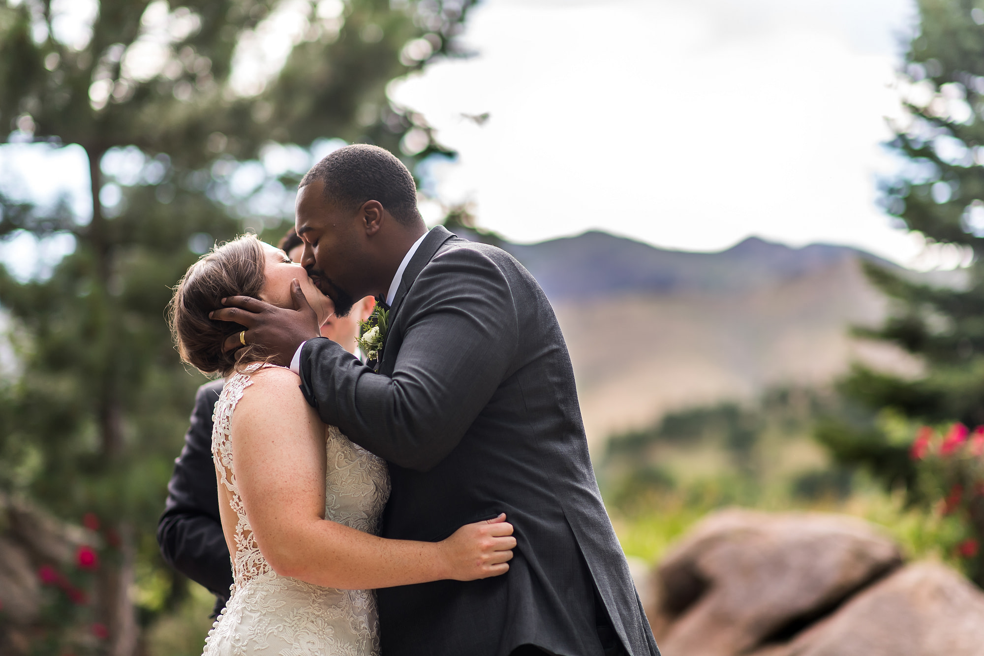 Groom kisses bride during Greenbriar Inn wedding in Boulder, Colorado.