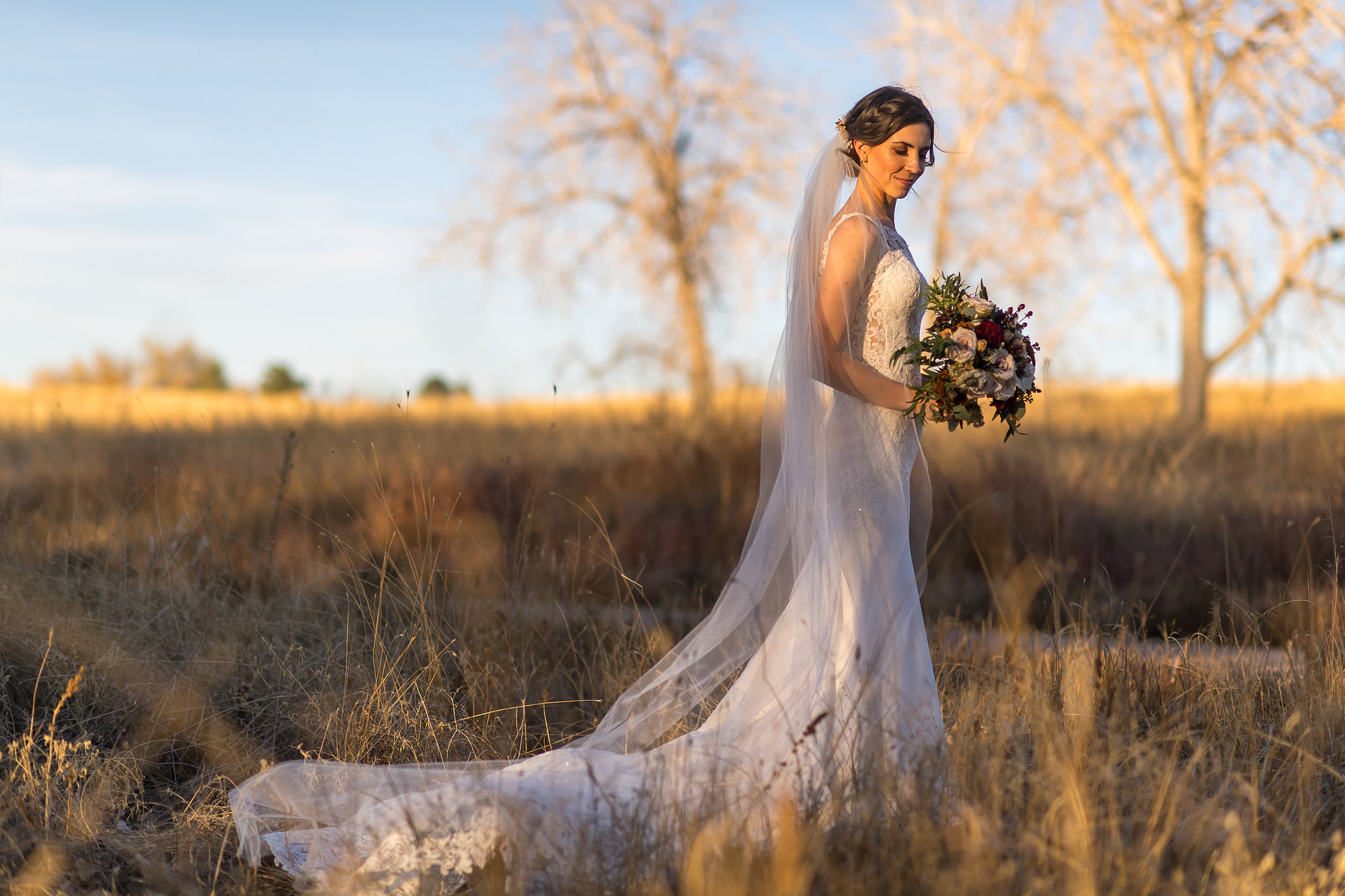 Bride poses for photos at Cherry Creek State Park in Aurora, Colorado.