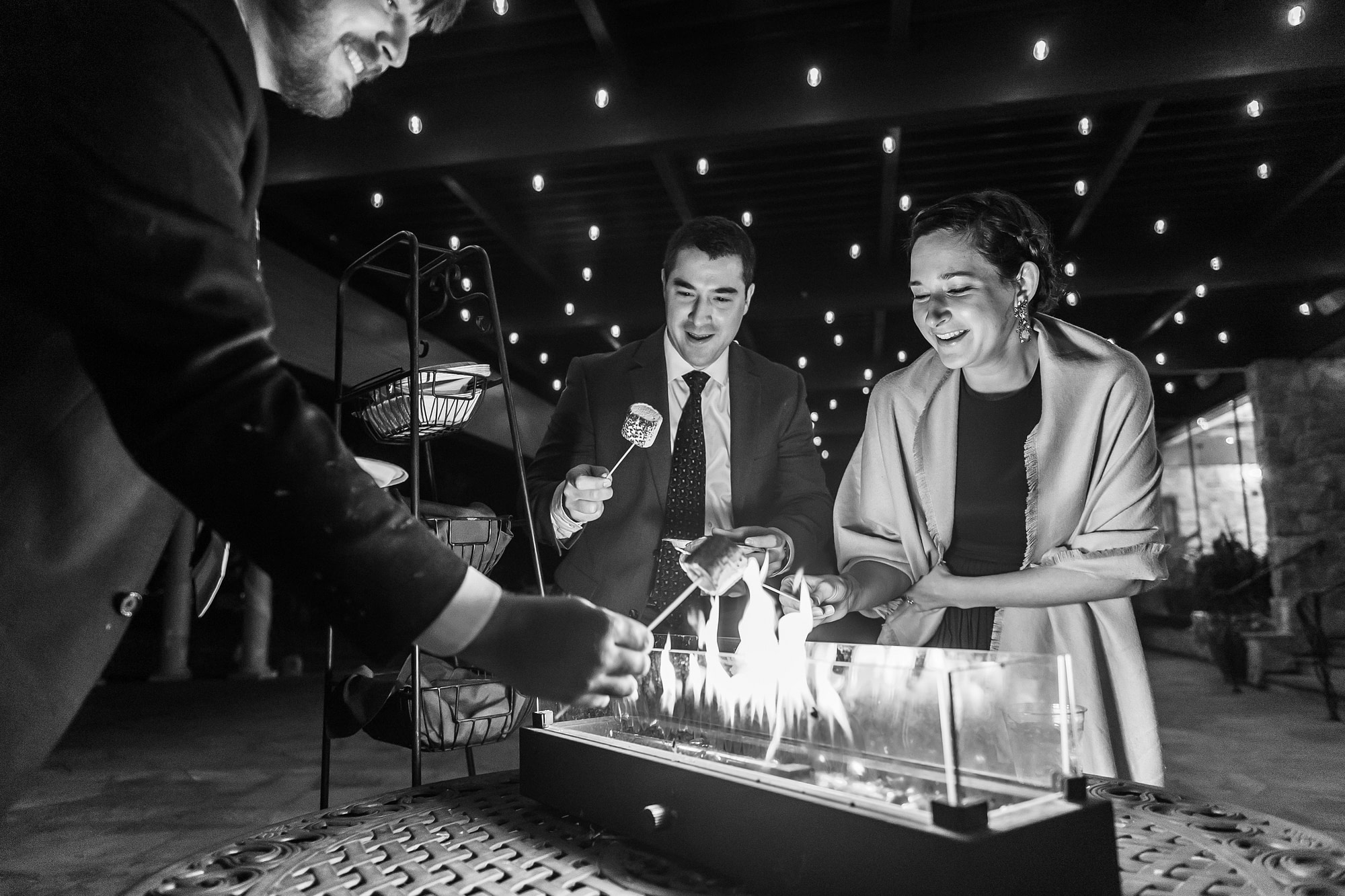 Guests roast s'mores at Baldoria on the Water wedding venue in Lakewood, Colorado.