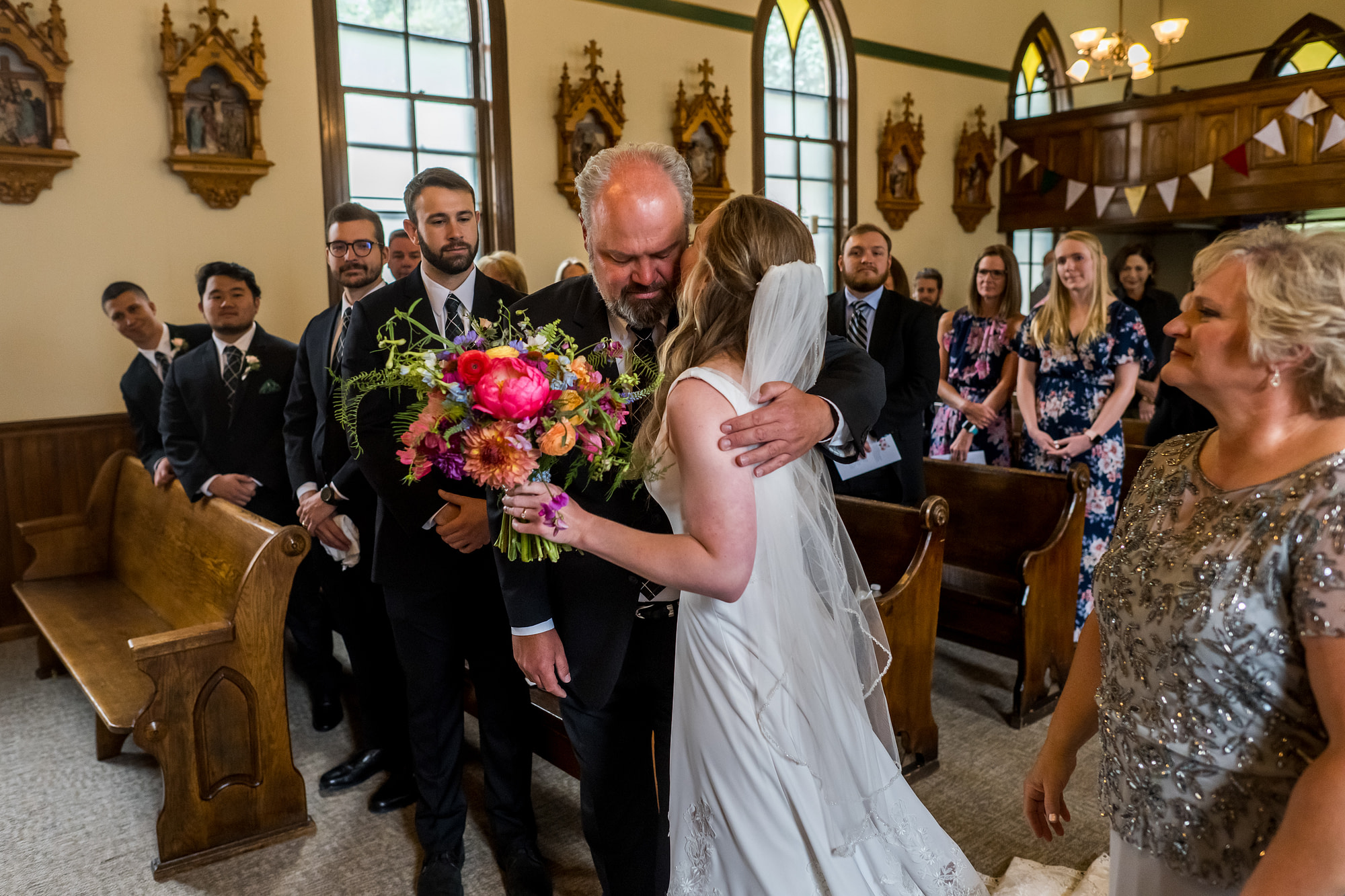 The bride embraces her father during her Telluride, Colorado, wedding at St. Patrick's Catholic Church.
