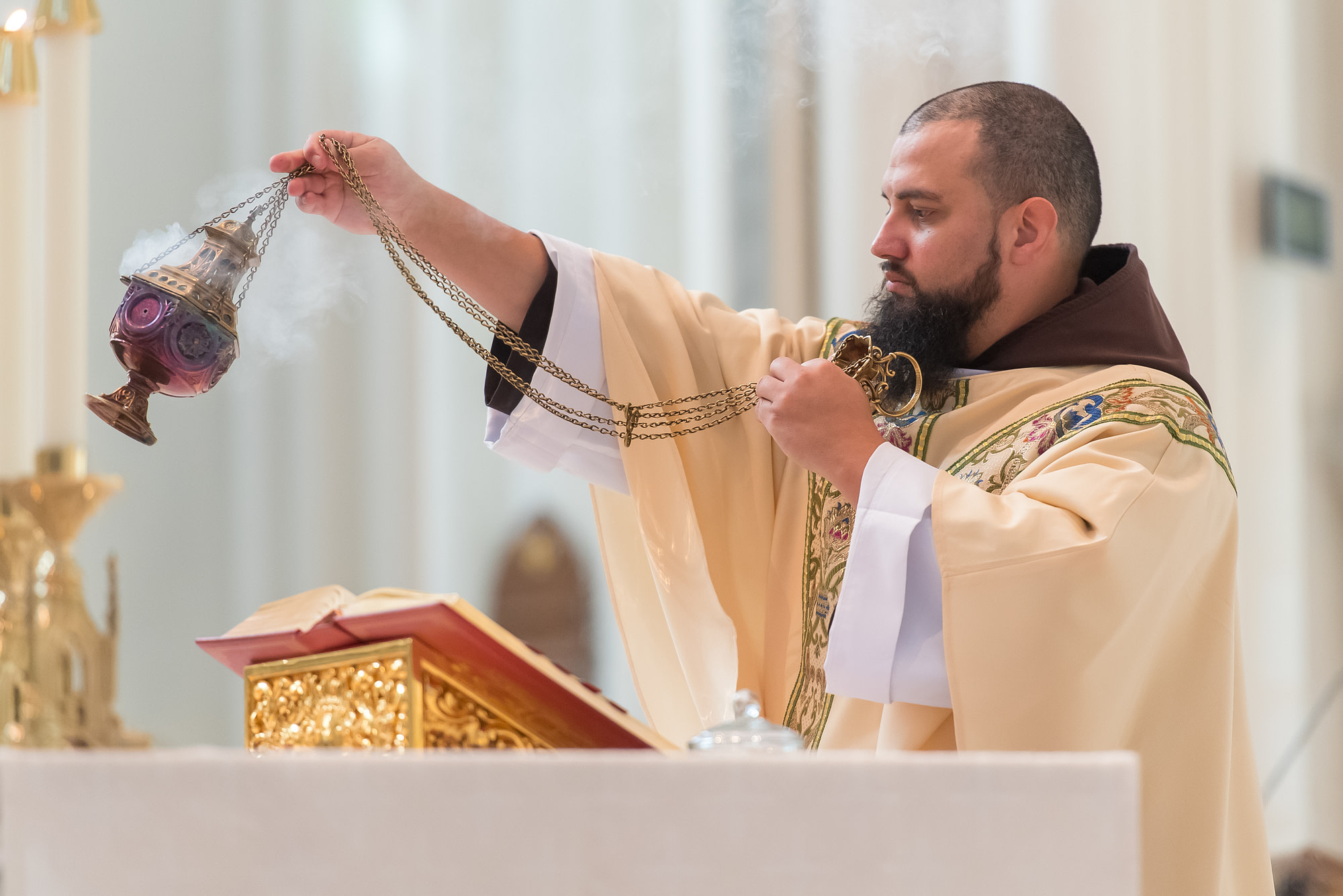 The priest offers up incense during a Cathedral Basilica of the Immaculate Conception wedding in Denver, Colorado.