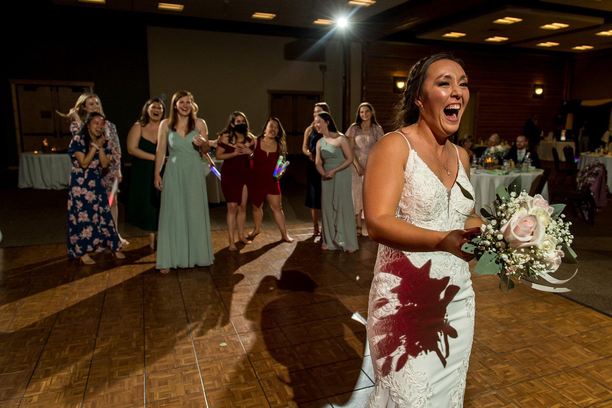 Bride prepares to throw the bouquet during a YMCA of the Rockies wedding in Estes Park, Colorado.