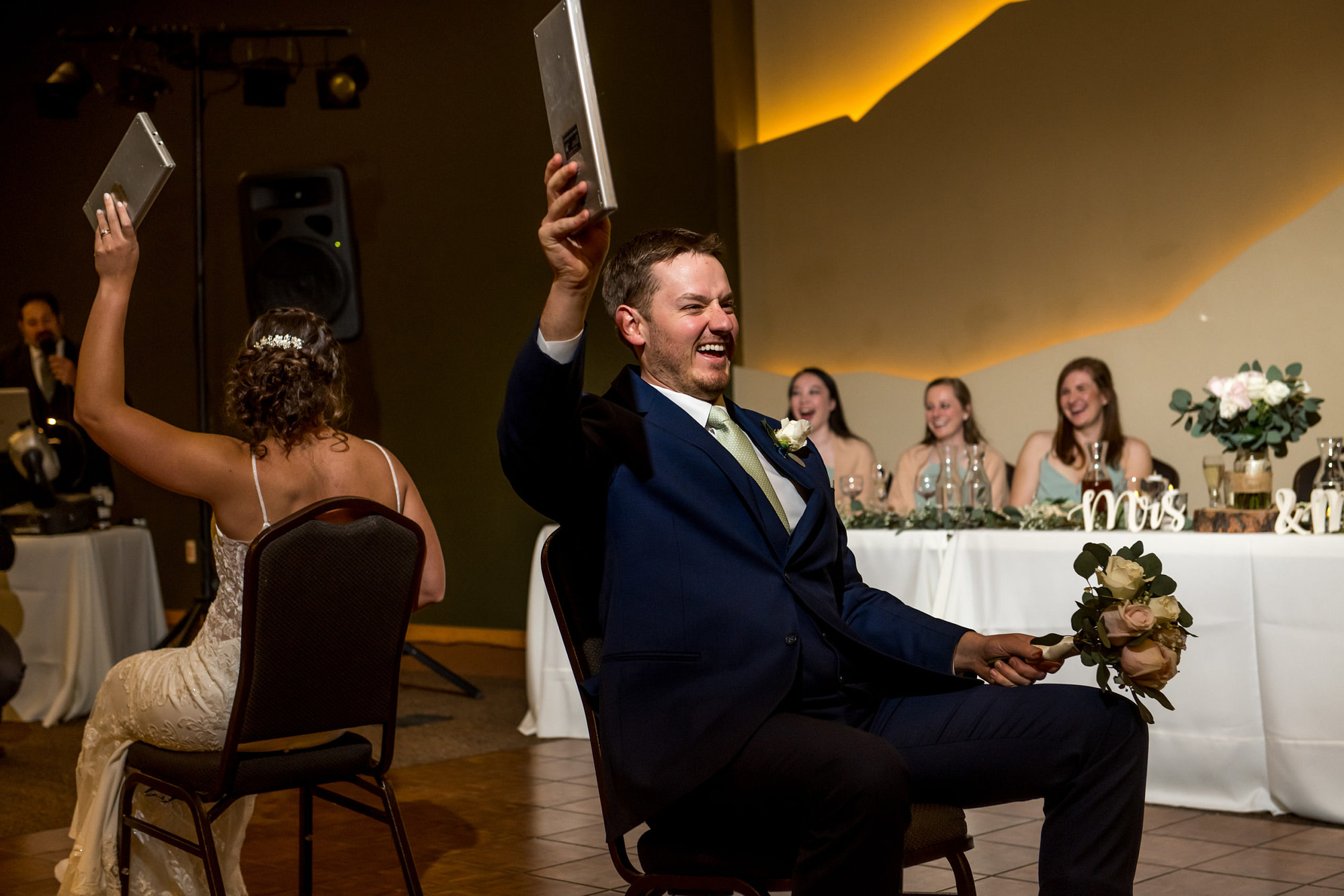 Bride and groom play a game during their YMCA of the Rockies wedding in Estes Park, Colorado.