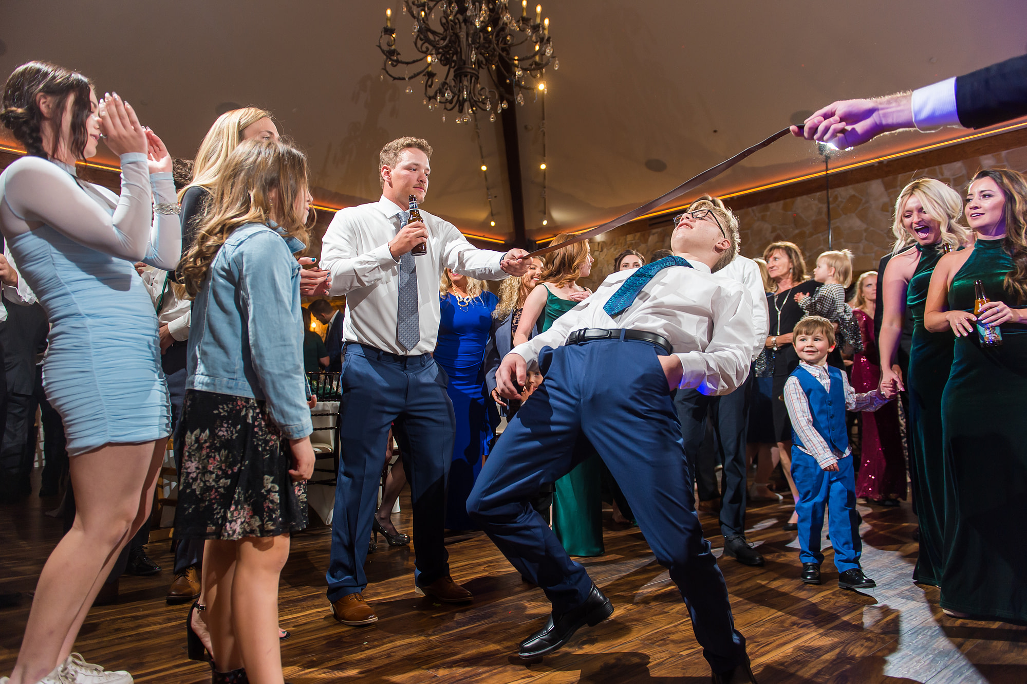 Guests dance at Baldoria on the Water wedding venue in Lakewood, Colorado.