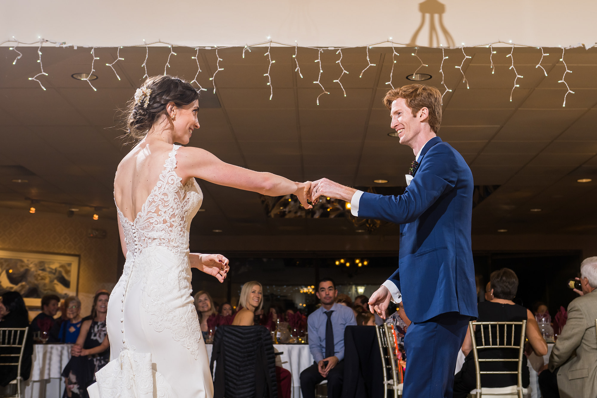 Bride and groom dance during a wedding reception at the Franciscan Event Center in Centennial, Colorado.