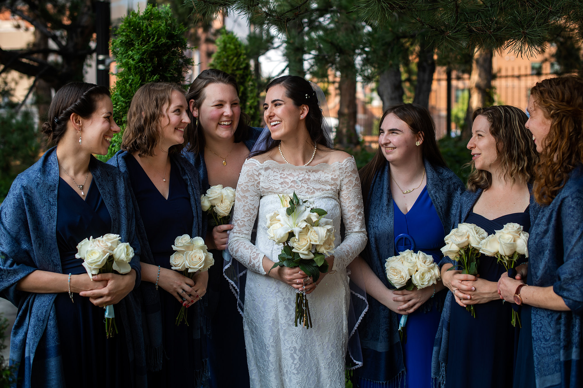 Aurora and bridesmaids talk after her wedding at the Cathedral Basilica of the Immaculate Conception in Denver, Colorado.