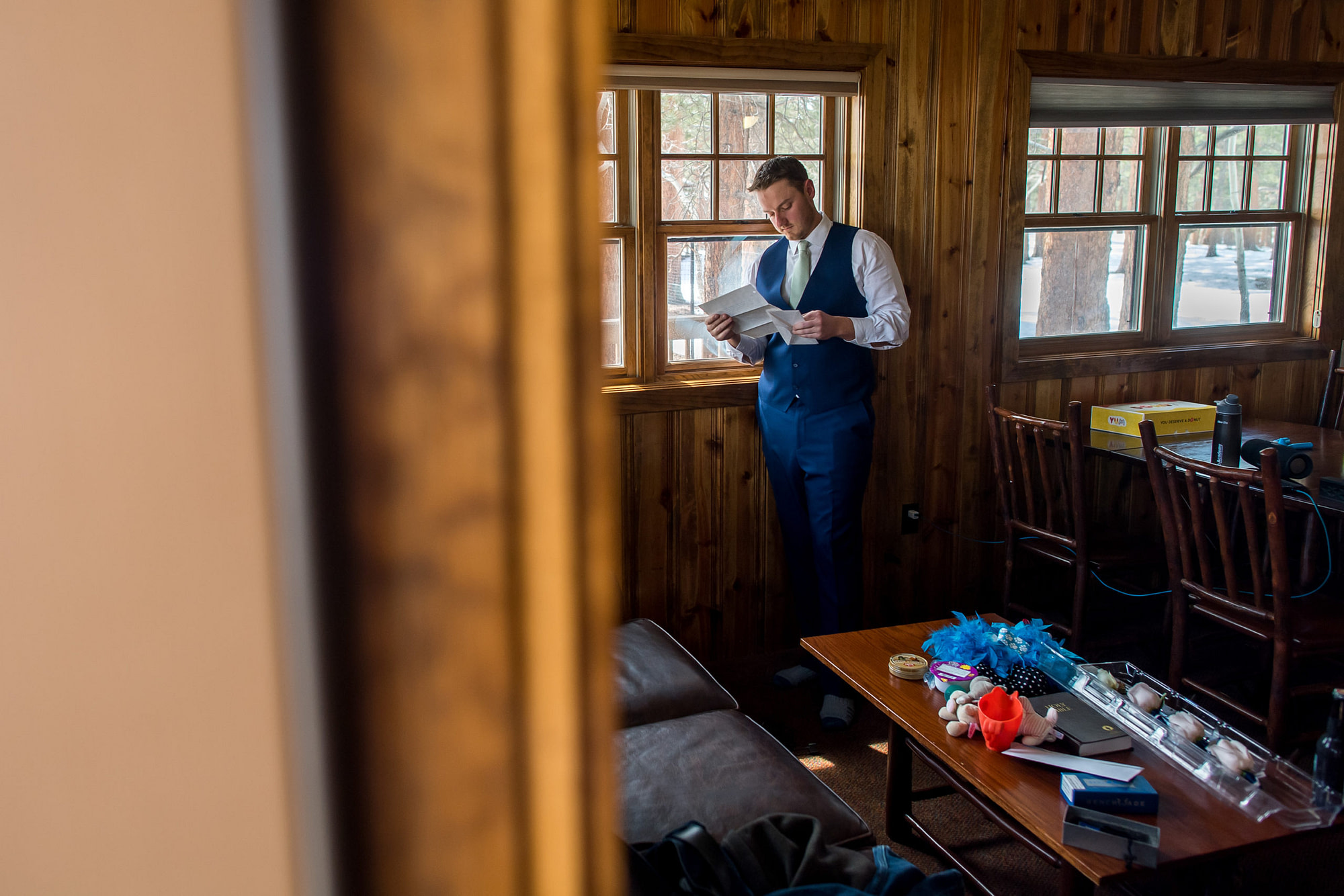 The groom reads a letter from the bride during their YMCA of the Rockies wedding in Estes Park, Colorado.