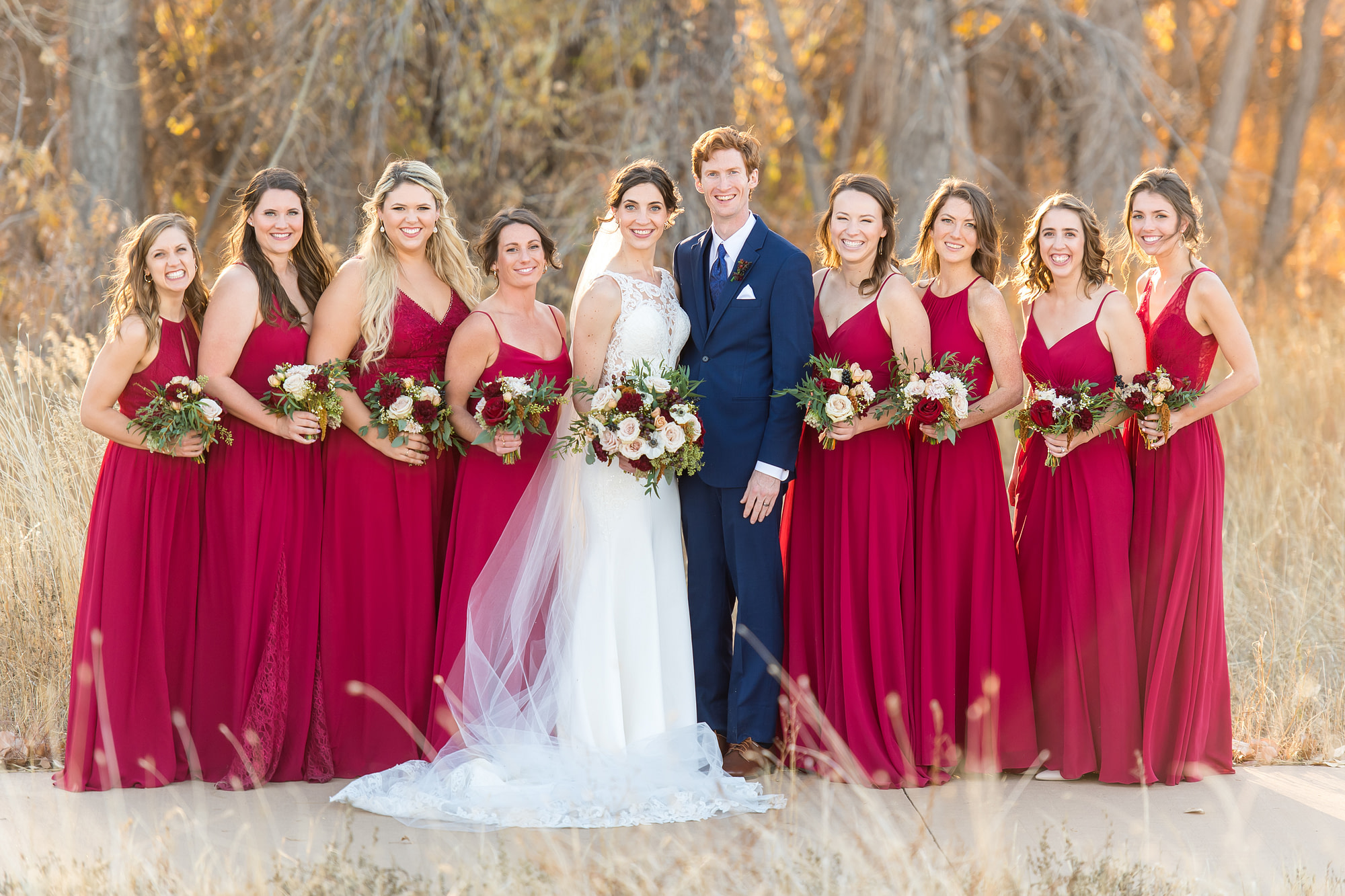Bride and groom pose with bridesmaids at Cherry Creek State Park in Aurora, Colorado.