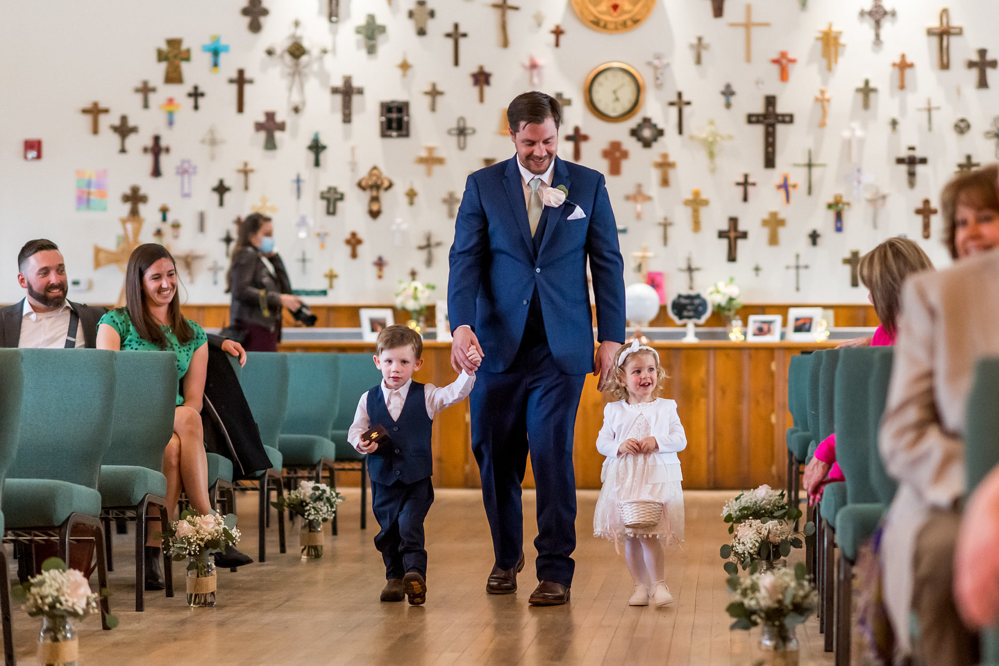 The flower girl and ring bearer process in during a YMCA of the Rockies wedding in Estes Park, Colorado.