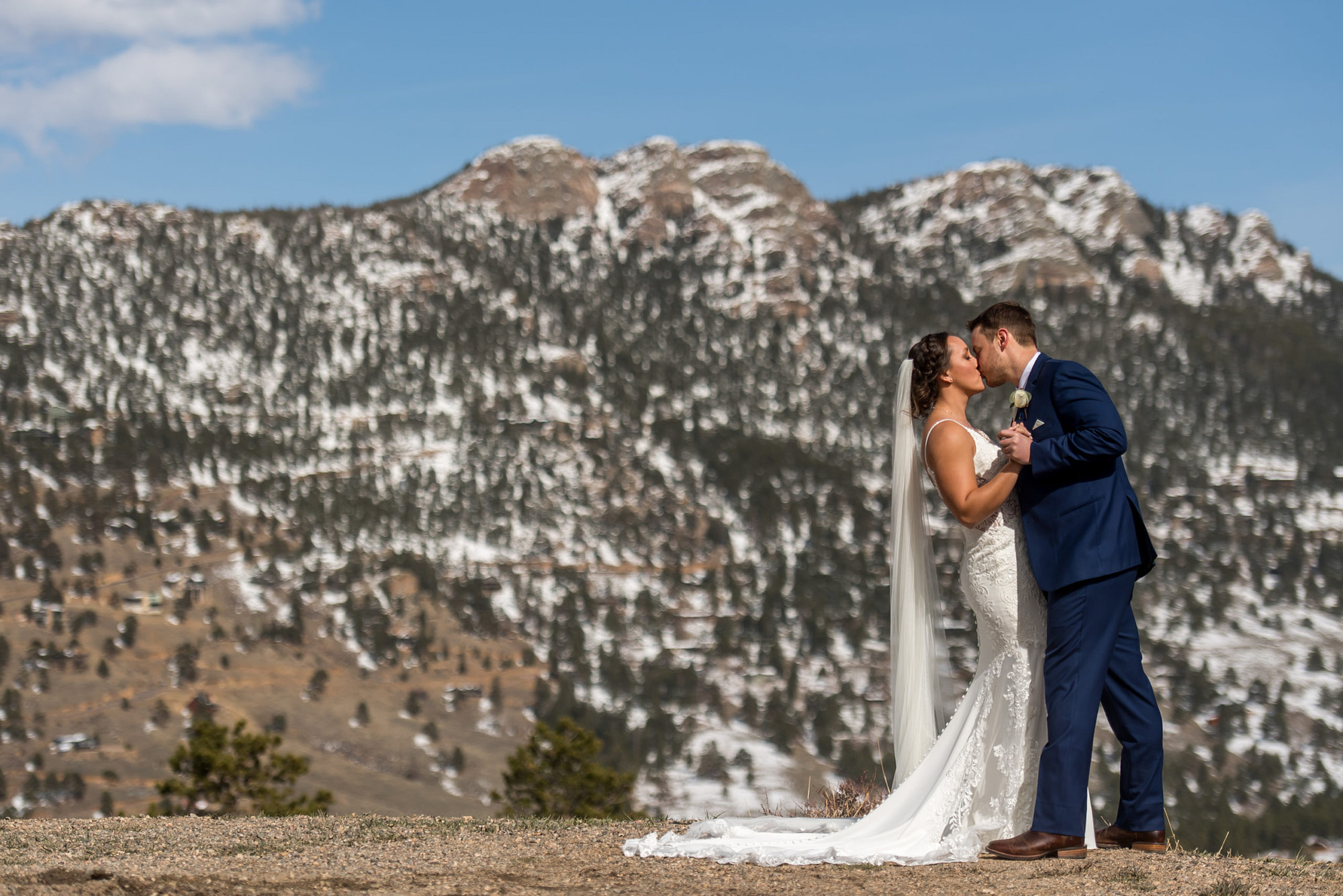 The bride and groom kiss during their YMCA of the Rockies wedding in Estes Park, Colorado.