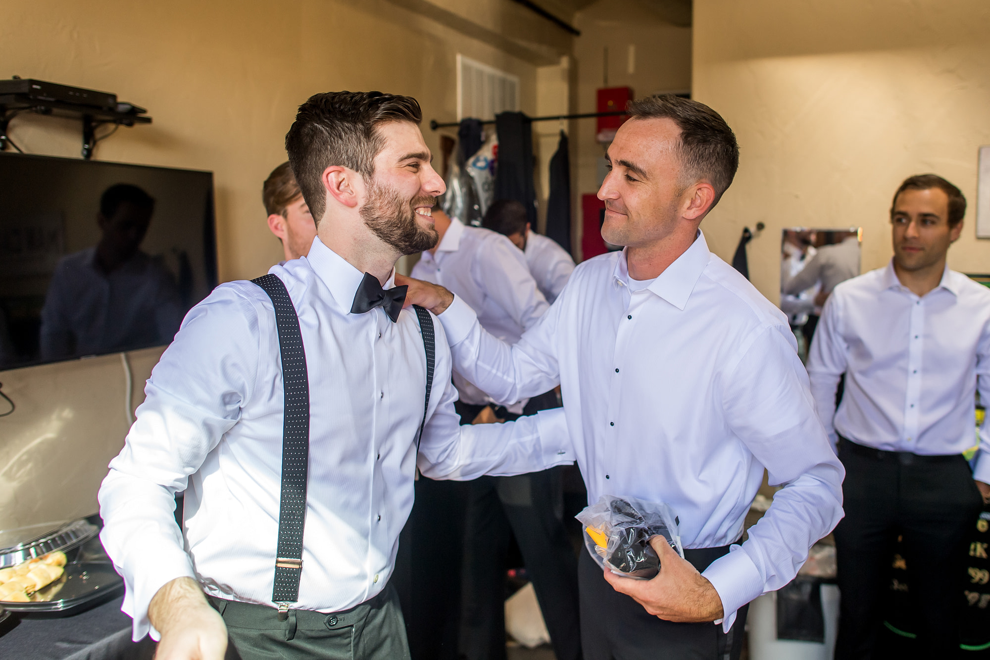 Groom spends time with groomsmen at Baldoria on the Water in Lakewood, Colorado.
