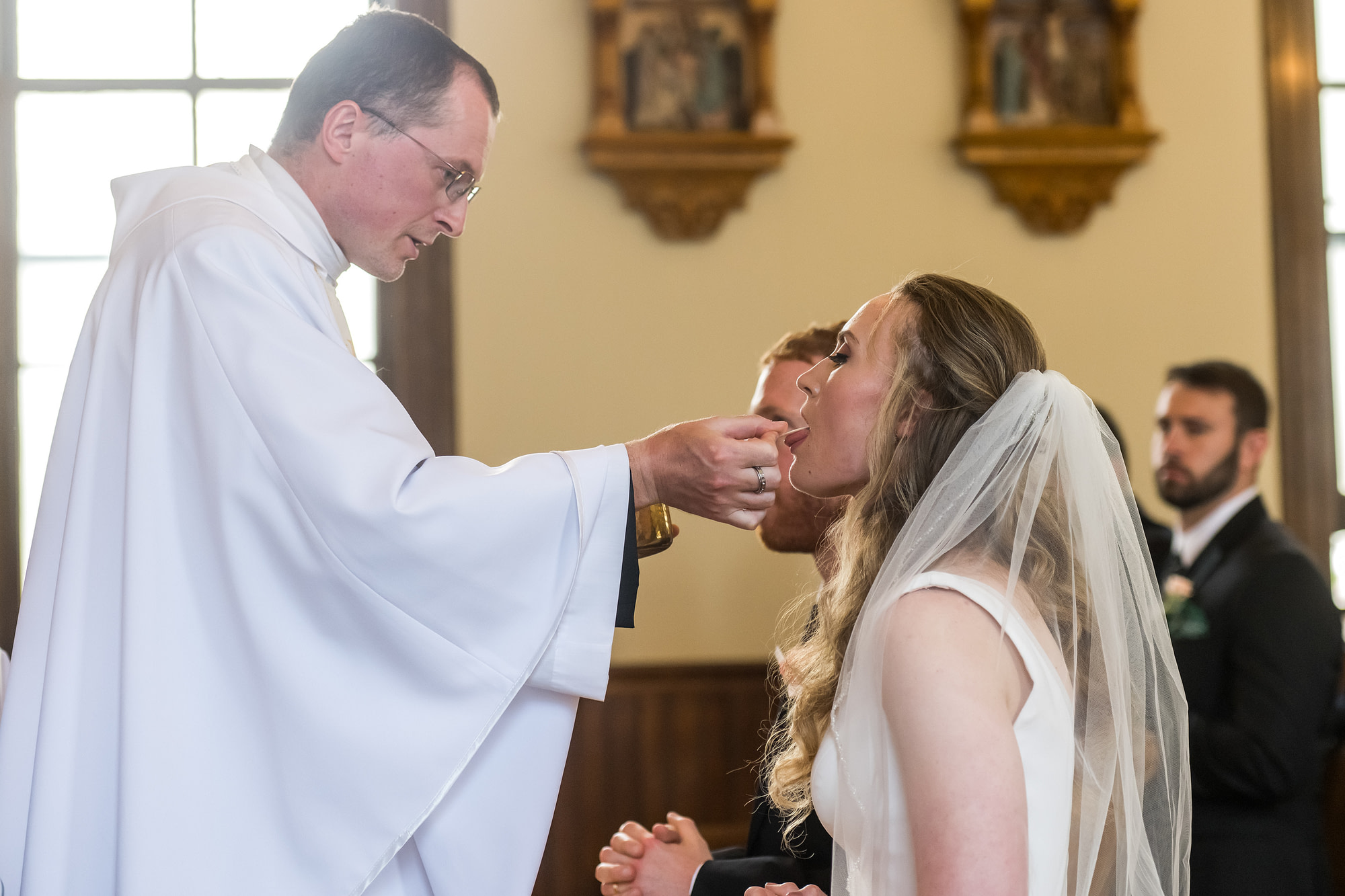 The bride eats a consecrated host during his wedding at St. Patrick's Church Telluride.
