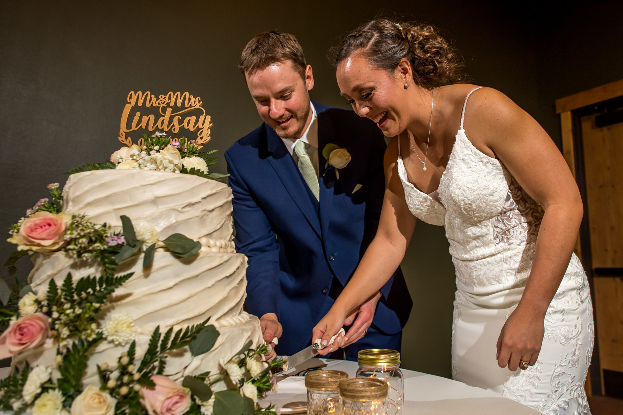 Bride and groom cut the cake during their YMCA of the Rockies wedding in Estes Park, Colorado.